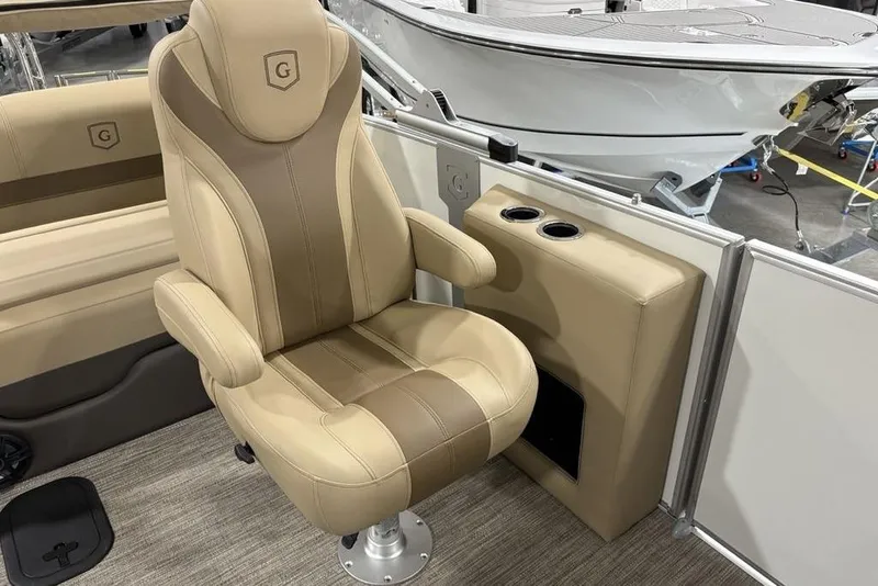 Slide: The Image of Luxurious seating on 2026 Godfrey Monaco 235 SFL boat, featuring beige upholstery and cup holders. - 19