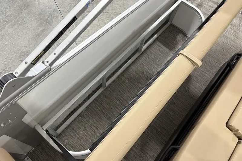 Slide: The Image of 2026 Godfrey Monaco 235 SFL boat interior with beige seating and storage compartment. - 21