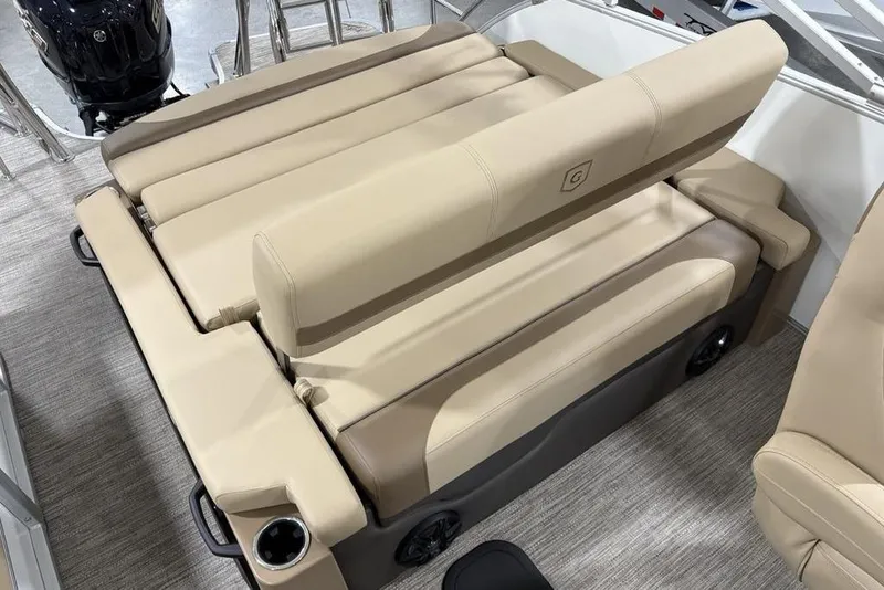 Slide: The Image of 2026 Godfrey Monaco 235 SFL boat interior with beige seating and cup holders. - 24