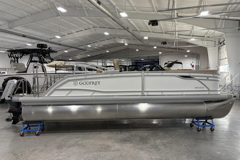 Slide: The Image of 2026 Godfrey Monaco 235 SFL pontoon boat in a spacious indoor showroom. - 31