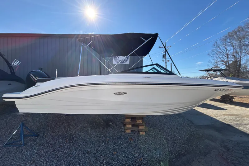 The Image of 2023 Searay SPX 210 OB boat displayed outdoors under clear sky. - 0