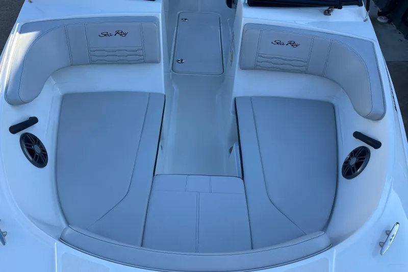 Slide: The Image of 2023 Searay SPX 210 OB boat interior with white cushioned seating. - 12