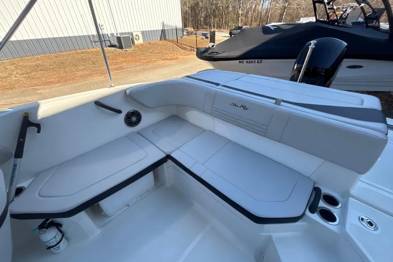 Slide: The Image of 2023 Searay SPX 210 OB boat interior with white seating and cup holders. - 22