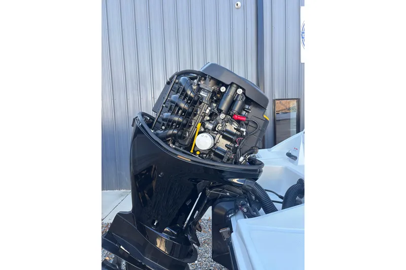Slide: The Image of 2023 Searay SPX 210 OB outboard motor, detailed view against metal wall. - 25