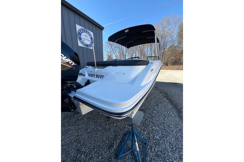Slide: The Image of 2023 Searay SPX 210 OB boat on display, featuring sleek design and Mercury outboard motor. - 9