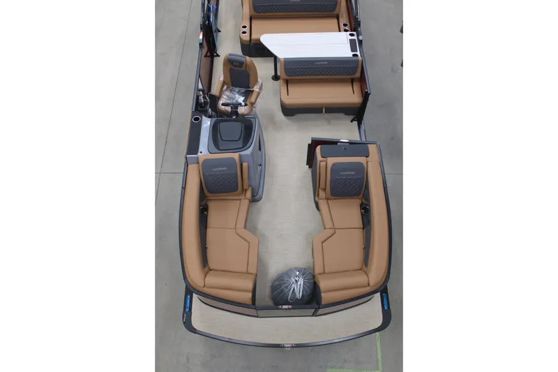 Slide: The Image of 2026 Harris Sunliner 230 boat interior with tan seating and modern design. - 2