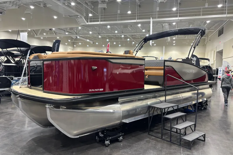 Slide: The Image of 2026 Harris Sunliner 230 pontoon boat displayed indoors with sleek design and modern features. - 4