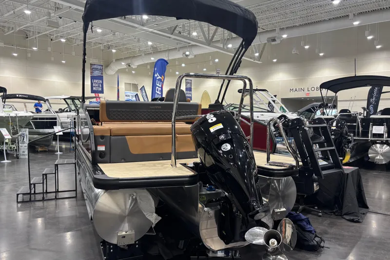 Slide: The Image of 2026 Harris Sunliner 230 pontoon boat displayed at an indoor boat show. - 5