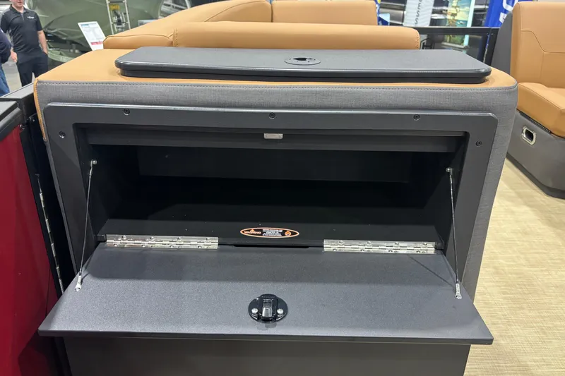 Slide: The Image of 2026 Harris Sunliner 230 storage compartment with open lid, showcasing interior space. - 8