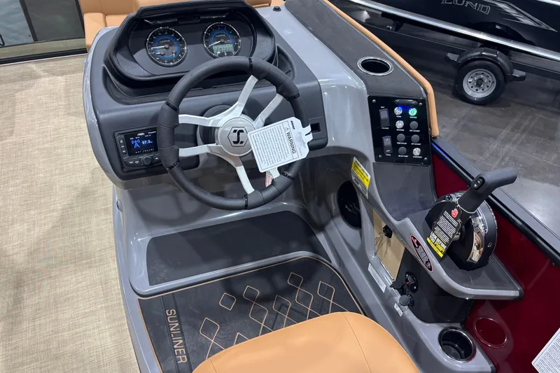 Slide: The Image of 2026 Harris Sunliner 230 boat dashboard with steering wheel, controls, and instrument panel. - 9