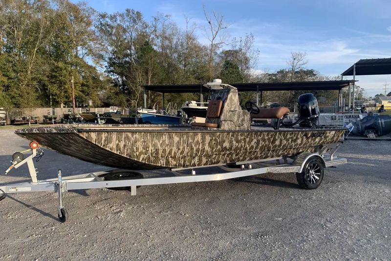 Slide: The Image of 2026 Avid 21 Recon ST boat with camouflage design on a trailer. - 7