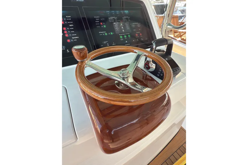 Slide: The Image of Steering wheel and controls of 2026 Mag Bay 38 CC boat, featuring modern dashboard. - 4