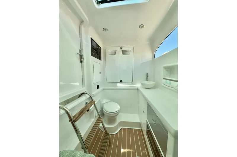 Slide: The Image of 2026 Mag Bay 38 CC boat interior with modern bathroom and wooden flooring. - 7