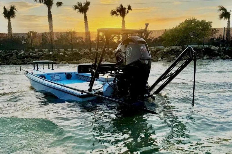 The Image of Dusky 16 Custom 2017 boat on water at sunset with palm trees in background. - 0