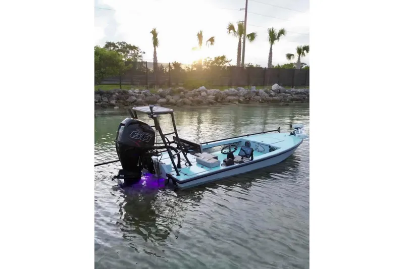 Slide: The Image of 2017 Dusky 16 Custom boat in calm waters under a blue sky. - 2