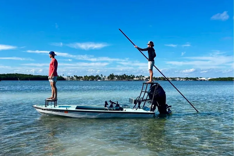 Slide: The Image of Two people on a 2017 Dusky 16 Custom boat in shallow water, one poling. - 4