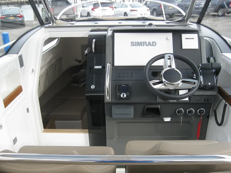 Slide: The Image of 2024 Nimbus T9 boat cockpit with Simrad navigation system and modern steering wheel. - 18