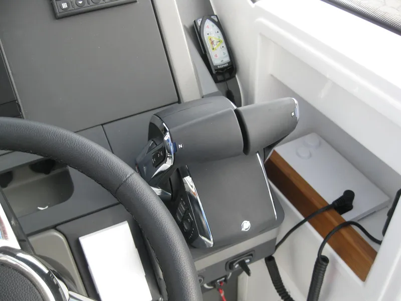 Slide: The Image of 2024 Nimbus T9 boat throttle control and steering wheel. - 24