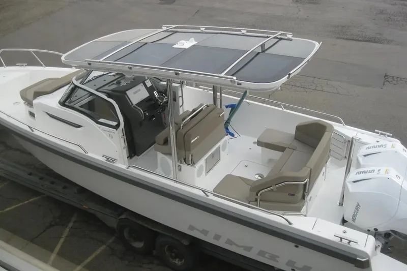 Slide: The Image of 2024 Nimbus T9 boat with sleek design, spacious seating, and modern controls, parked on a trailer. - 3