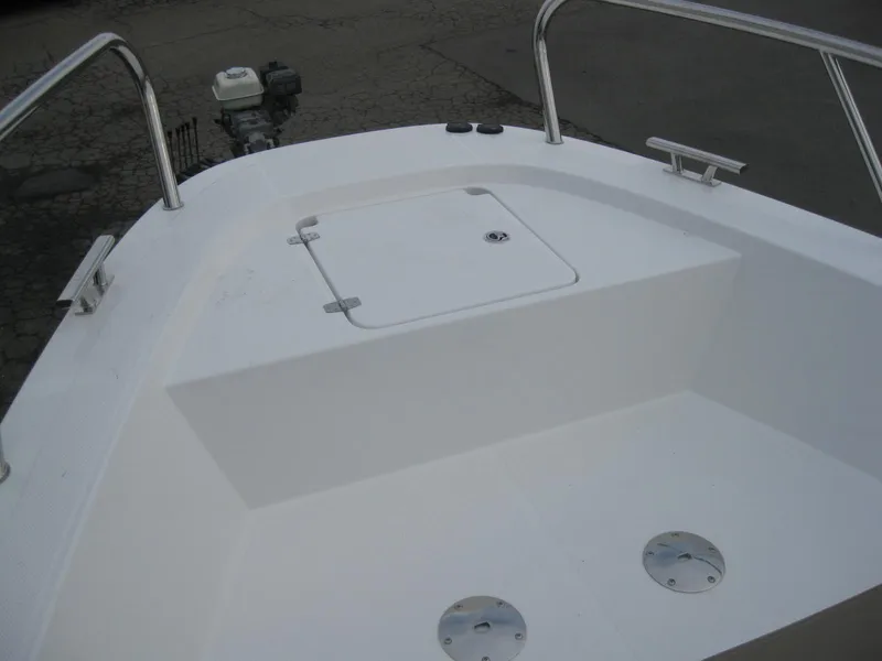 Slide: The Image of 2024 Nimbus T9 boat deck with storage compartment and railing. - 38