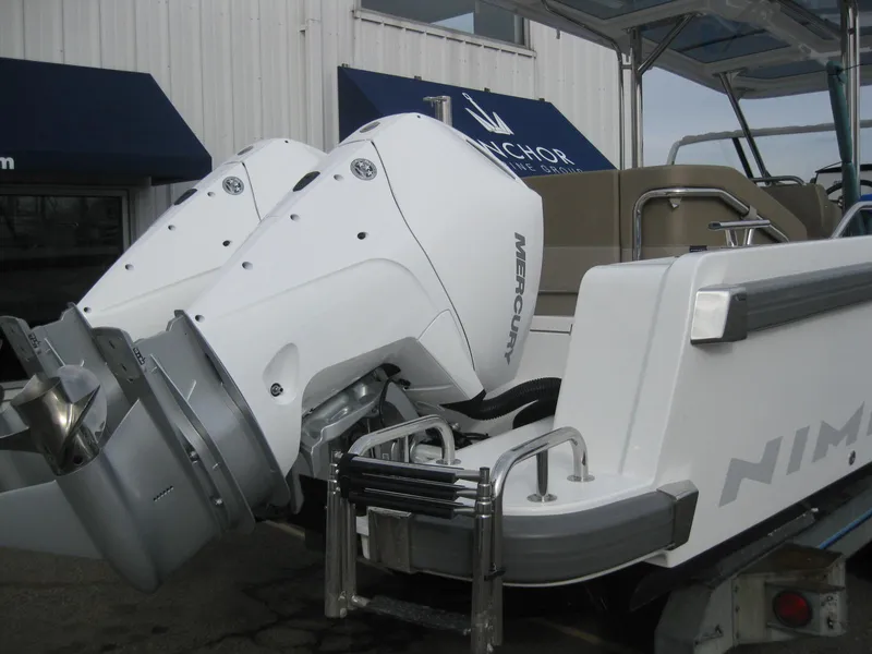 Slide: The Image of 2024 Nimbus T9 boat with dual Mercury outboard engines at Anchor dealership. - 8