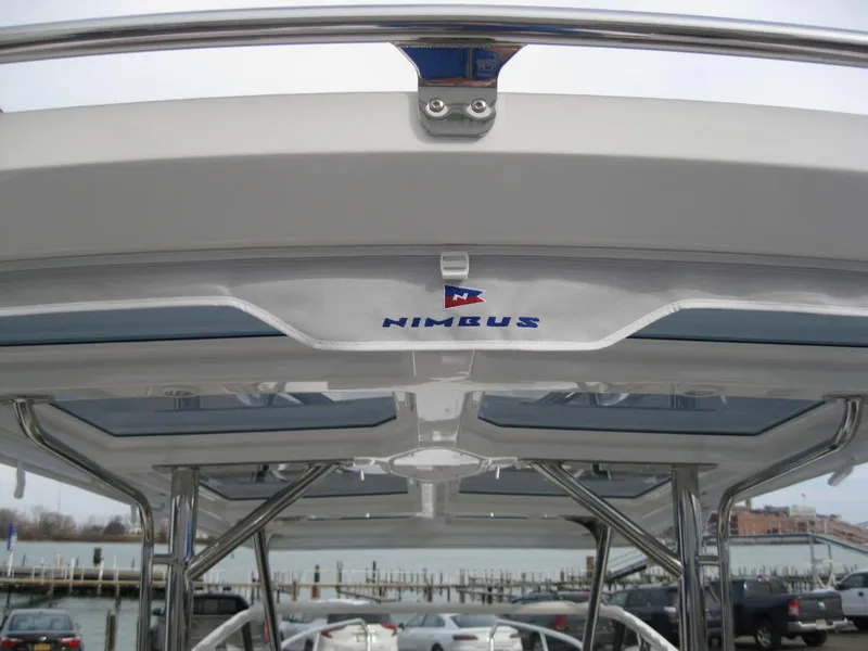 Slide: The Image of 2024 Nimbus T9 boat roof with logo at marina. - 14