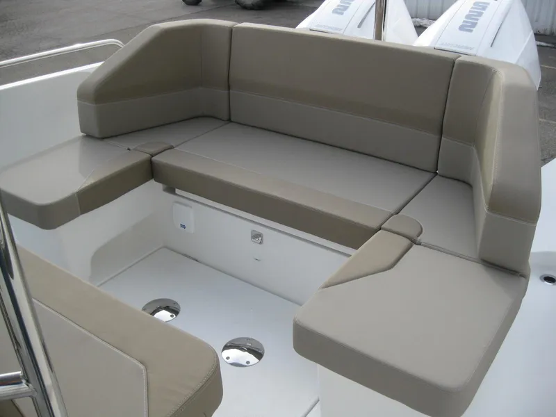 Slide: The Image of 2024 Nimbus T9 boat with beige cushioned seating area. - 15