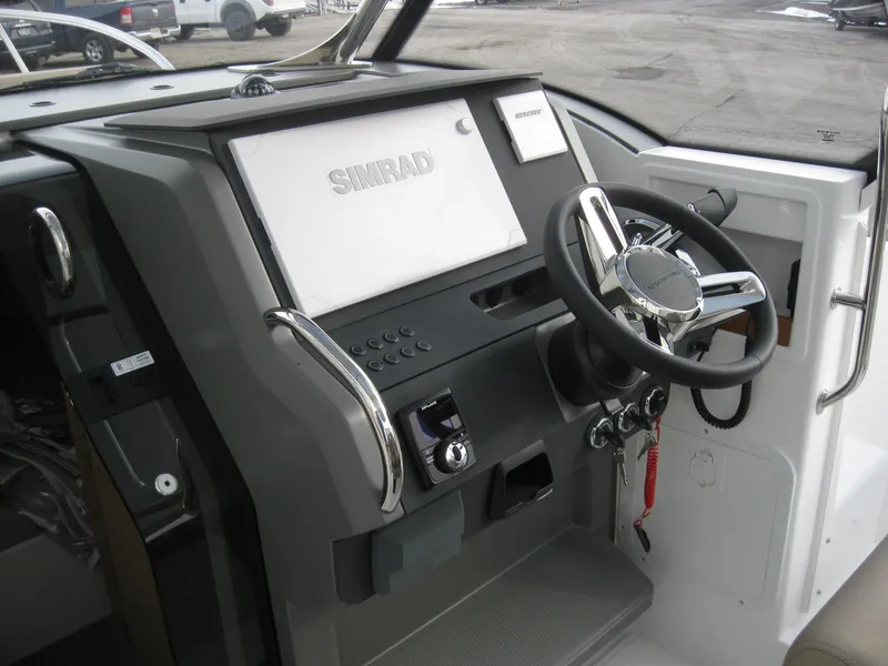 Slide: The Image of 2024 Nimbus T9 boat dashboard with Simrad navigation system and steering wheel. - 19