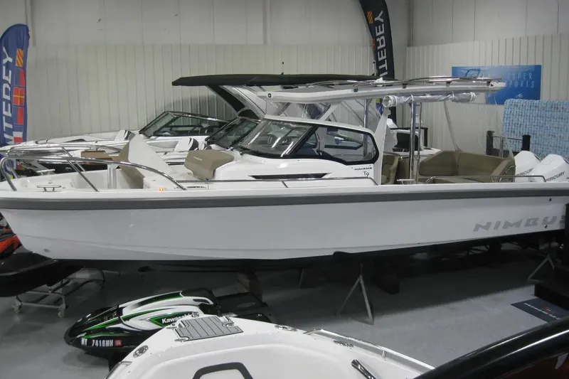 Slide: The Image of 2024 Nimbus T9 boat displayed indoors at a showroom with other watercraft. - 2