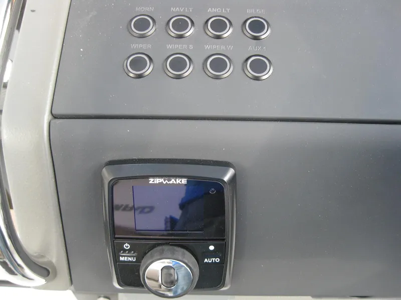 Slide: The Image of Control panel of 2024 Nimbus T9 boat with Zipwake system and various buttons. - 23