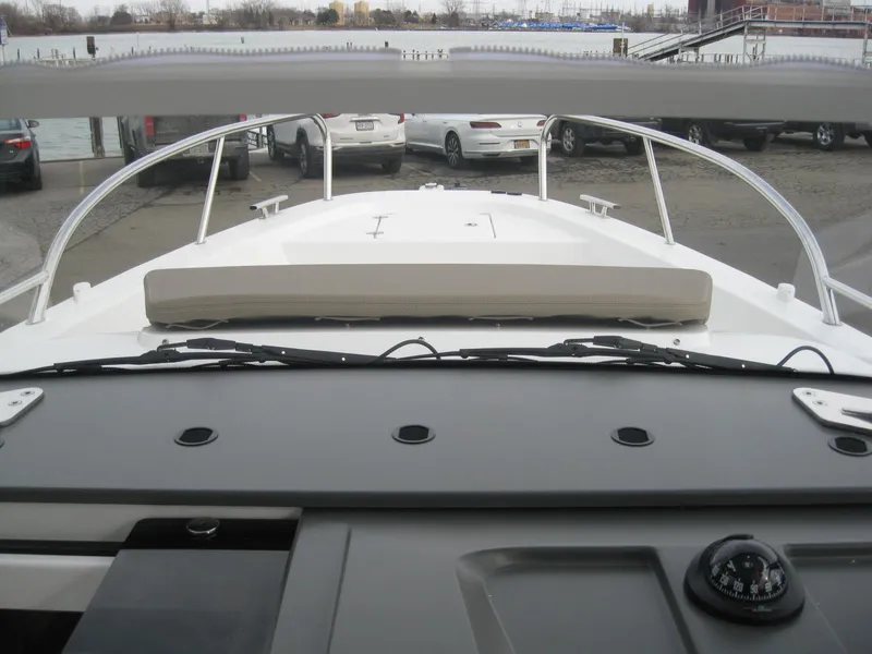 Slide: The Image of View from the helm of a 2024 Nimbus T9 boat docked at a marina. - 28