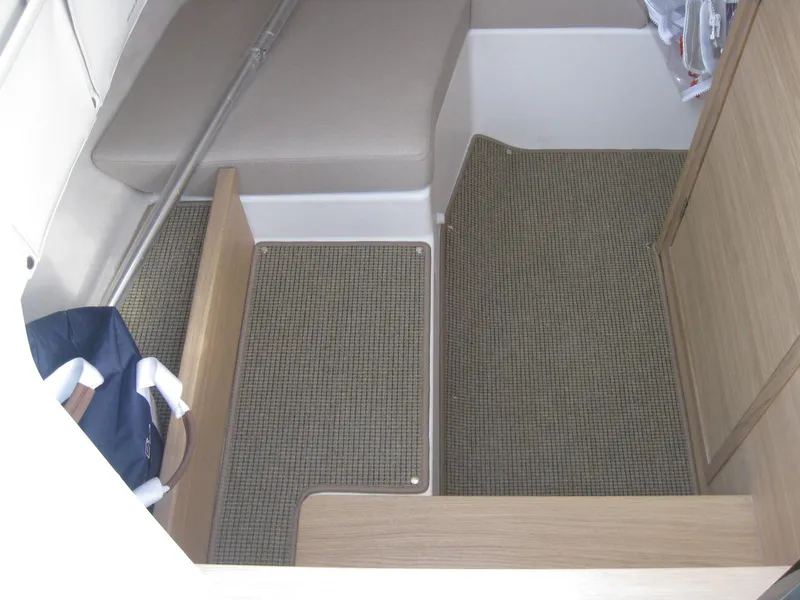 Slide: The Image of Interior cabin of 2024 Nimbus T9 boat with carpeted flooring and seating area. - 29