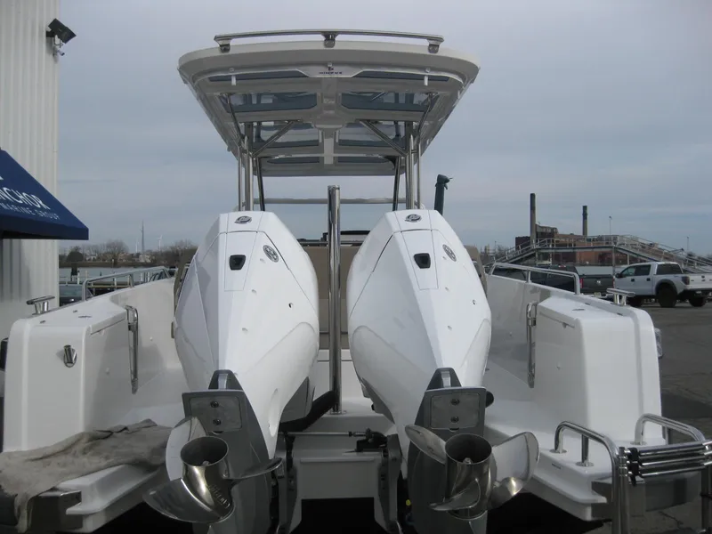 Slide: The Image of 2024 Nimbus T9 boat with dual outboard engines at a marina. - 9
