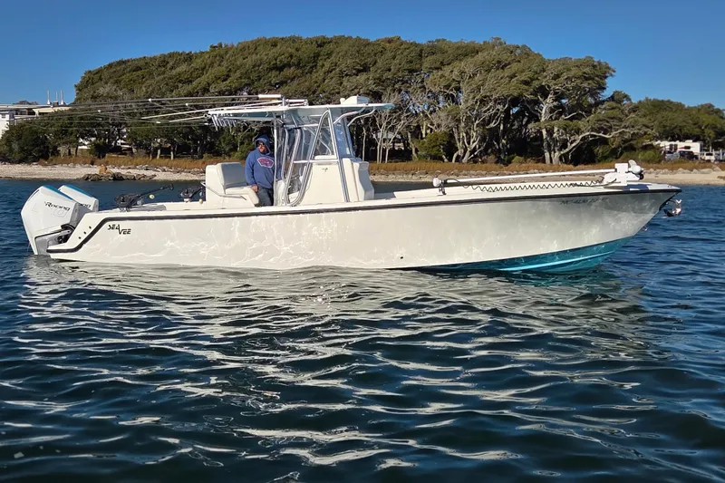 Slide: The Image of 2017 SeaVee 320B boat on water, with trees and shoreline in background. - 1