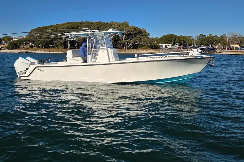 Slide: The Image of 2017 SeaVee 320B boat on calm water near a wooded shoreline. - 11