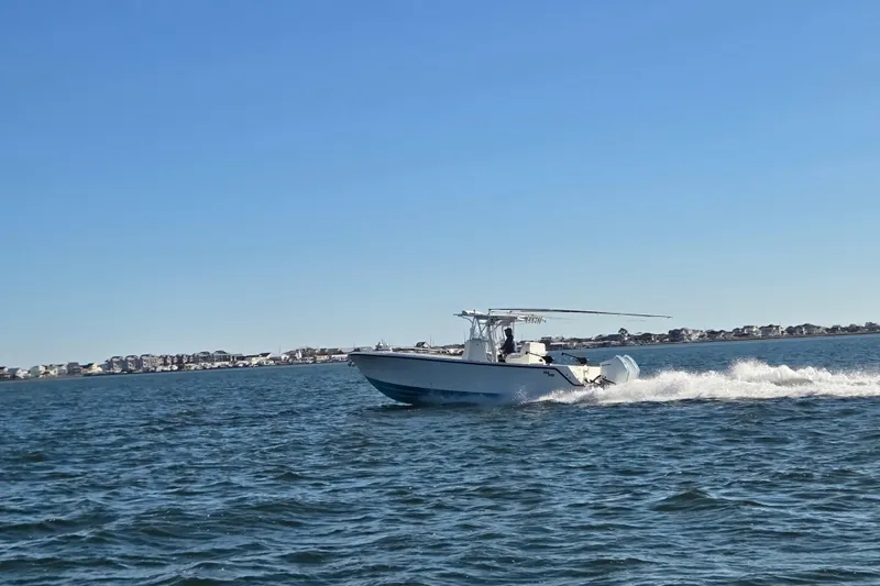 Slide: The Image of 2017 SeaVee 320B boat cruising on open water under clear blue sky. - 13
