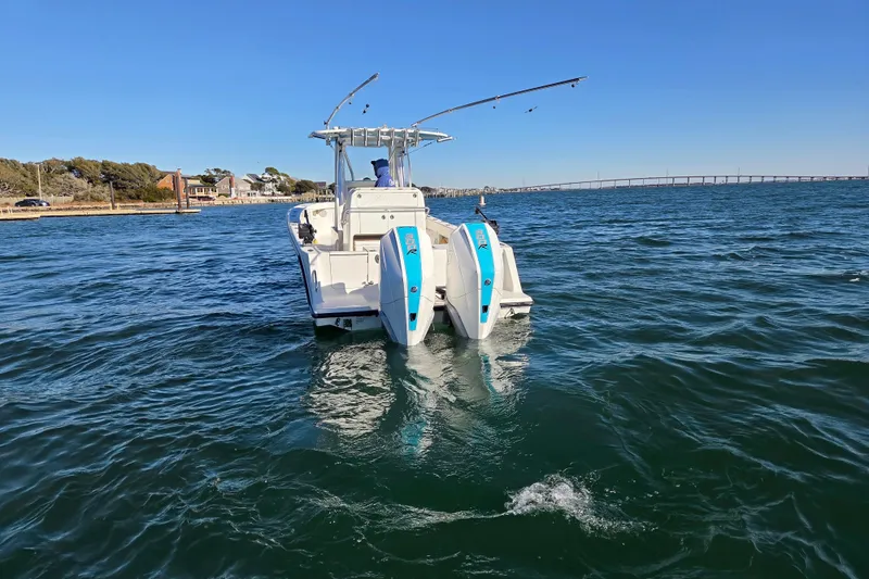 Slide: The Image of 2017 SeaVee 320B boat on open water with dual engines and clear sky. - 2