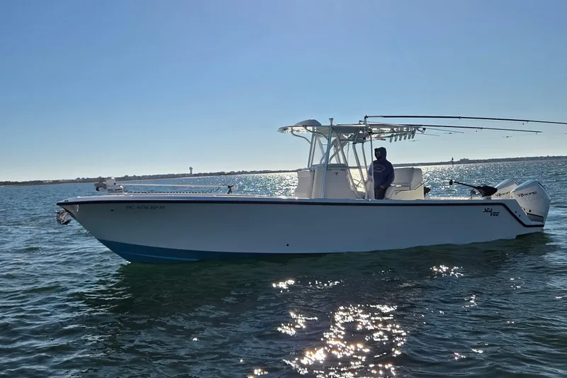 Slide: The Image of 2017 SeaVee 320B boat on water, sunny day, person onboard. - 7