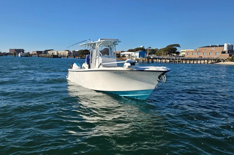 Slide: The Image of 2017 SeaVee 320B boat on water near coastal buildings under clear blue sky. - 9