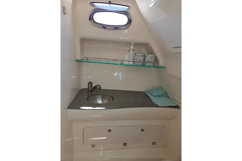 Slide: The Image of 2016 Boston Whaler 315 Conquest bathroom with sink, shelf, and window. - 14