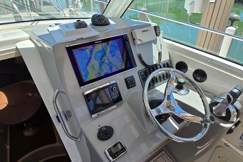 Slide: The Image of 2016 Boston Whaler 315 Conquest helm with navigation system and controls. - 7