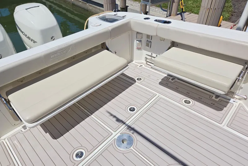 Slide: The Image of 2016 Boston Whaler 315 Conquest boat deck with foldable seating and clean design. - 9