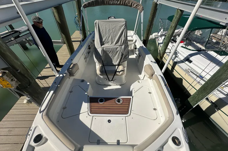 Slide: The Image of 2017 NauticStar 211 Angler boat docked, interior view with covered console. - 4