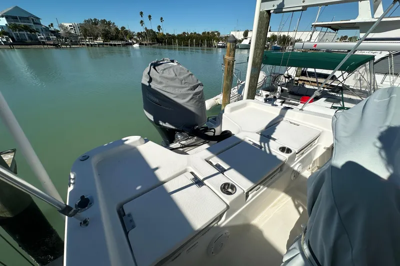 Slide: The Image of 2017 NauticStar 211 Angler boat docked, featuring covered Yamaha outboard motor. - 7