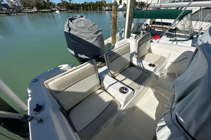 Slide: The Image of 2017 NauticStar 211 Angler boat interior with cushioned seating and cup holders. - 8