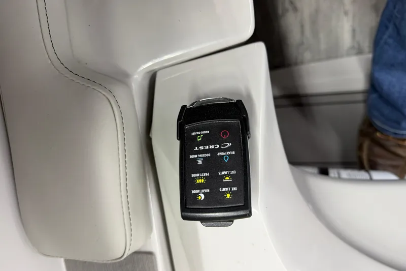 Slide: The Image of Control panel of a 2022 Crest Continental 250 SLS boat, featuring various function buttons. - 17