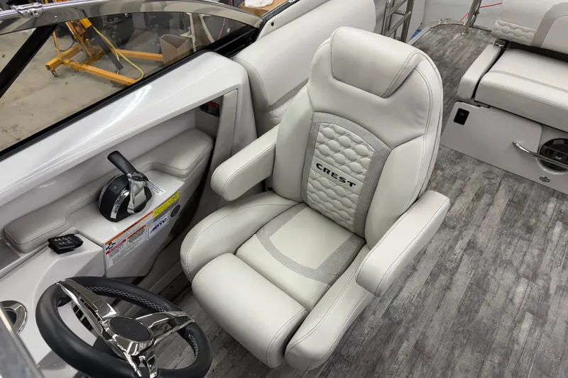 Slide: The Image of 2022 Crest Continental 250 SLS boat interior with luxurious captain's chair and steering controls. - 21
