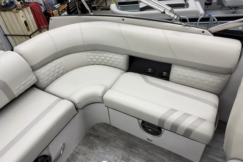 Slide: The Image of Luxurious seating on 2022 Crest Continental 250 SLS boat, featuring elegant white upholstery and cup holders. - 22
