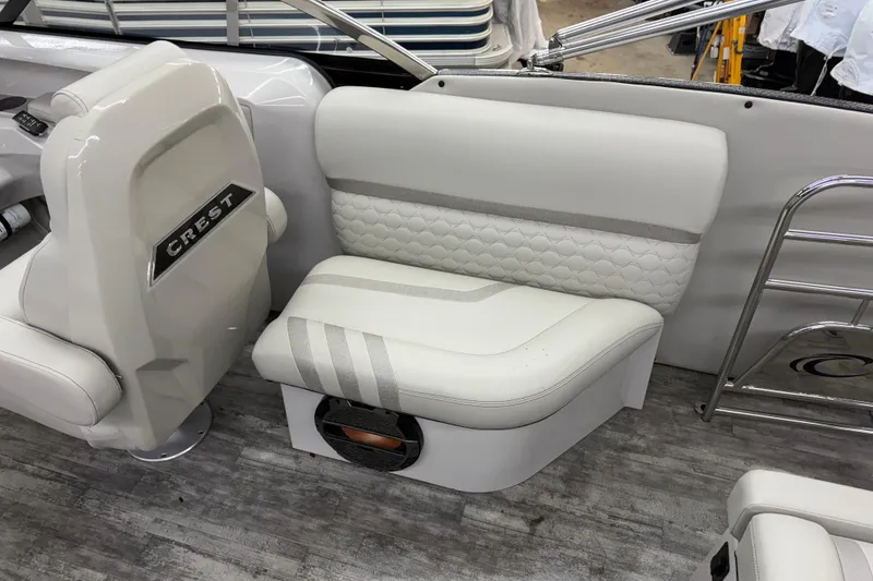 Slide: The Image of 2022 Crest Continental 250 SLS boat interior with white seating and modern design. - 24