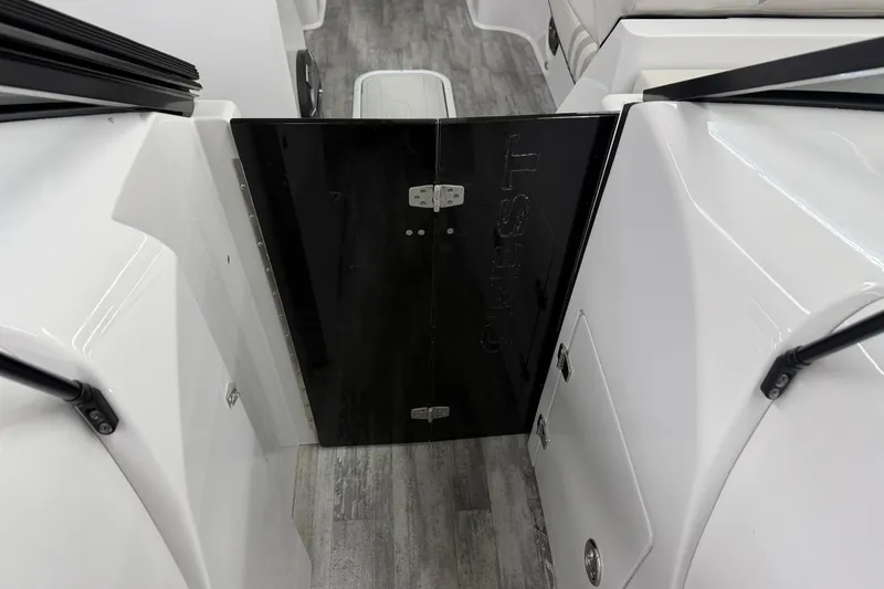 Slide: The Image of 2022 Crest Continental 250 SLS boat interior with sleek black door and modern design. - 8